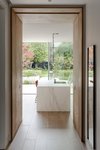 Open plan kitchen with marble island, view of landscaped garden in Wimbledon